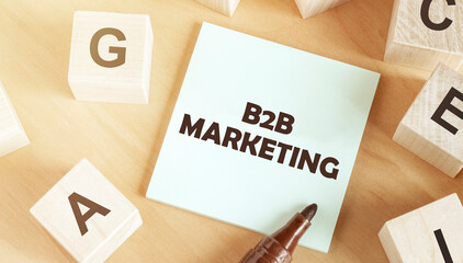 Sticker with text B2B marketing in the middle of wooden cubes with letters