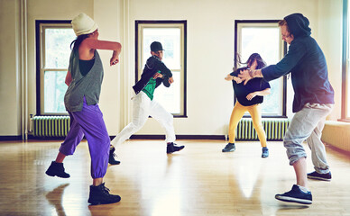 Naklejka premium Young and upcoming hip hop dancers. a group of young friends dancing together in a studio.