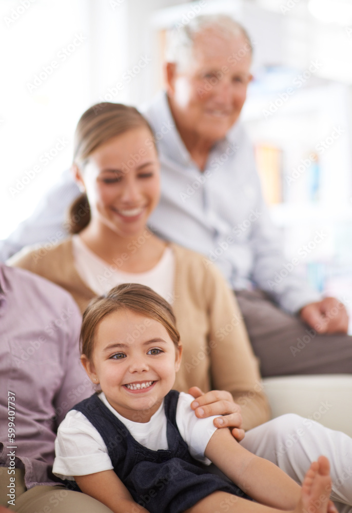 Sticker Were just one big happy family. Portrait of a smiling family sitting on the sofa at home.