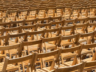 Rows of wooden folding chairs for outdoor performance 