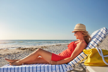 My view all day today. an attractive woman lying on a lounger at the beach.