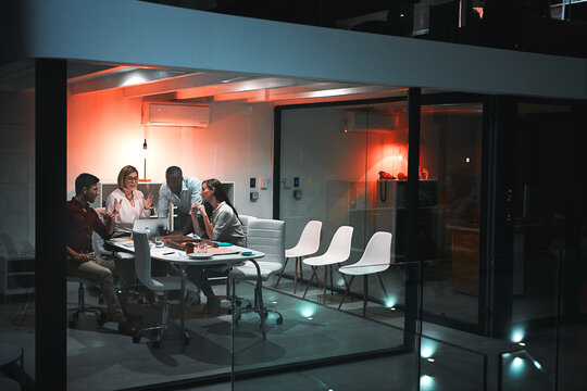 Teamwork is the best kind of work. colleagues having a meeting during a late night in a modern office.