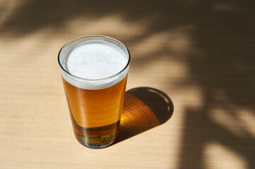 beer in glass cup on wooden table