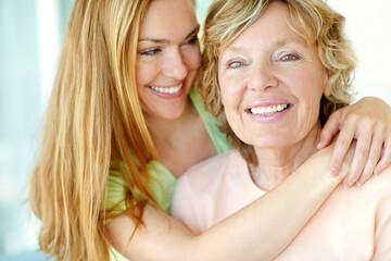 Showing her mother she loves her. A beautiful woman hugging her mother affectionately.