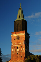 Naklejka premium Sunlit Bell Tower Of The Cathedral In Turku Finland On A Beautiful Sunny Summer Day With A Clear Blue Sky