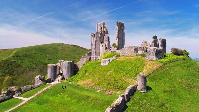 Telephoto aerial shot circling the ruins of Corfe Castle in Dorset	