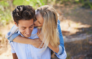 Youre my handsome hero. A young couple embracing while they stand outside.