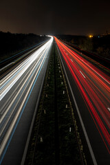 Cars light trails on a straight highway at sunset. Night traffic trails, Motion blur, Night city...