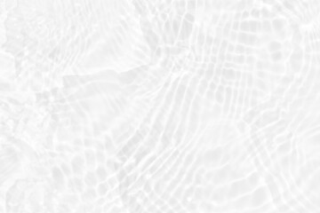 White water with ripples on the surface. Defocus blurred transparent white colored clear calm water surface texture with splashes and bubbles. Water waves with shining pattern texture background.