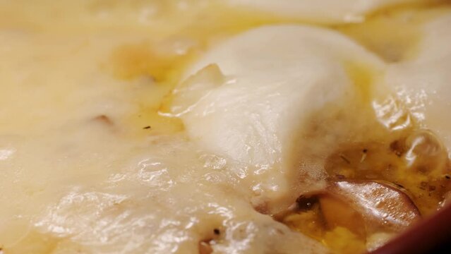 Melted cheese close up, melt pizza with cheese baking on tray in electric oven - macro, close up. Italian cuisine, homemade bakery, cooking food. 