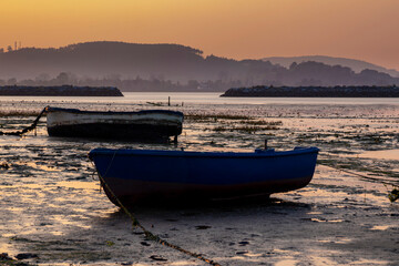 Naklejka premium Boats and Bridge in the Orange Sky of Laredo in spain