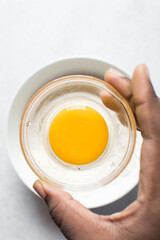 Organic raw egg in a glass bowl for baking and cooking