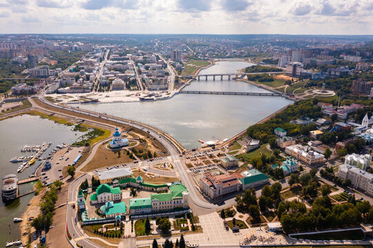 Scenic view from drone on sunny summer day of Cheboksary cityscape on banks of Volga river overlooking Holy Trinity Monastery and Assumption Church, Chuvashia, Russia