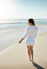 The beach is where my heart is at. a beautiful young woman enjoying her day at the beach.