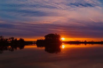 Fototapeta na wymiar Sunset with reflections near Mettenufer, Danube, Bavaria, Germany