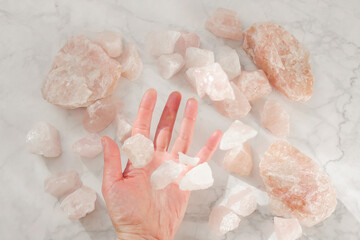  natural stone on rose quartz on gray marble background.precious gem stone. Pink talisman stone. 