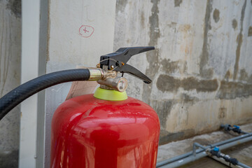 Handle of fire extinguisher for emergency fire incident. The photo is suitable to use for industry background photography, power plant poster and safety content media.