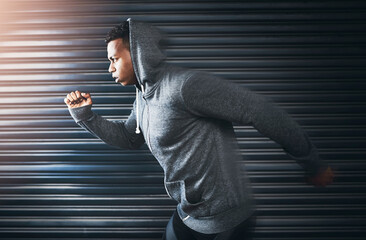 Excuses wont earn you any results. a sporty young man running against a grey background.