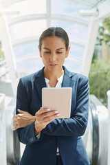 Researching on her way to work. a young businesswoman using a digital tablet on her way to the office.