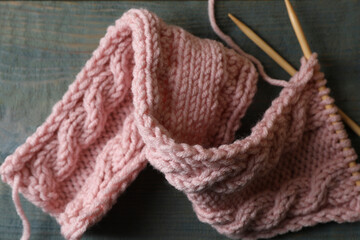 Fototapeta na wymiar Pink knitting and needles on wooden table, flat lay