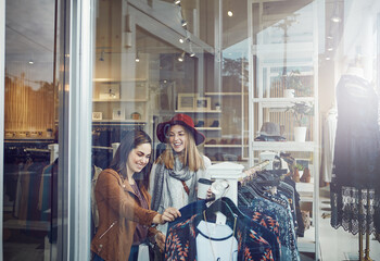 Its always a good time to go shopping. two best friends out shopping in a clothing store.