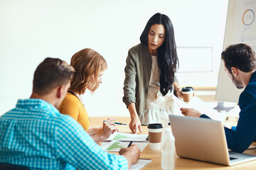 This is what I was looking for...an attractive young businesswoman giving a presentation in the boardroom.