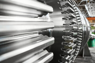Metal shaft of steam turbine without blades in workshop