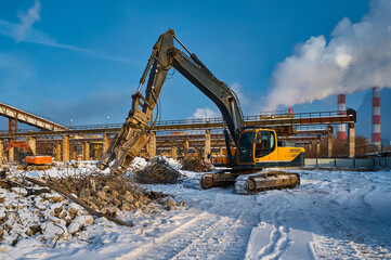 Hydraulic shears on excavator remove concrete and metal