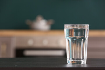 Glass of water on black table in kitchen