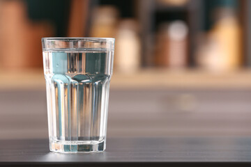 Glass of water on black table in kitchen