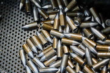 Scattered grey bullets armour ammunition as background