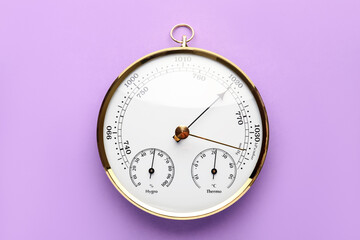 Aneroid barometer on purple background