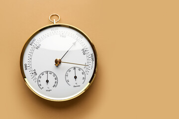 Aneroid barometer on brown background