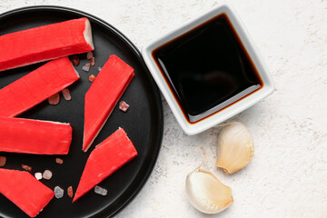 Plate with tasty crab sticks and sauce on light background, closeup © Pixel-Shot