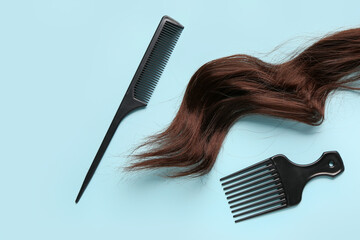 Wavy brown hair with brushes on blue background