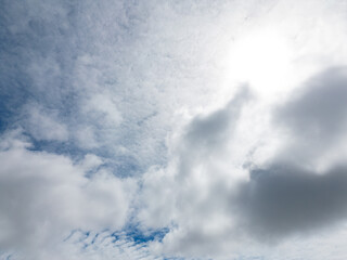 Experience the captivating beauty of fluffy white clouds drifting across a brilliant blue sky with...