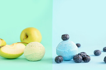 Bath bomb with apple and blueberry on colorful background