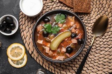 Bowl of tasty Hodgepodge soup on dark background