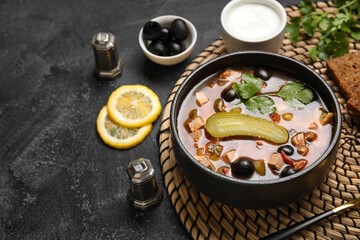 Bowl of tasty Hodgepodge soup on dark background