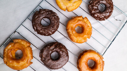 Old fashioned donuts with original and chocolate flavors in the photo in an elegant kitchen
