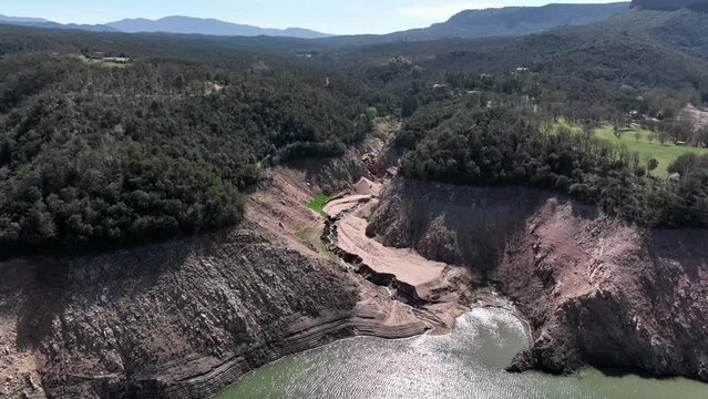 Establishing aerial view of Sau reservoir extreme low water level, severe droght
