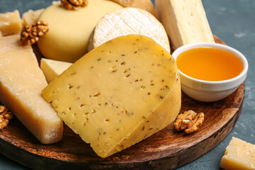 Plate with tasty cheese on table, closeup
