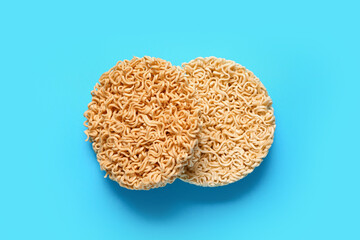 Raw instant noodles on blue background