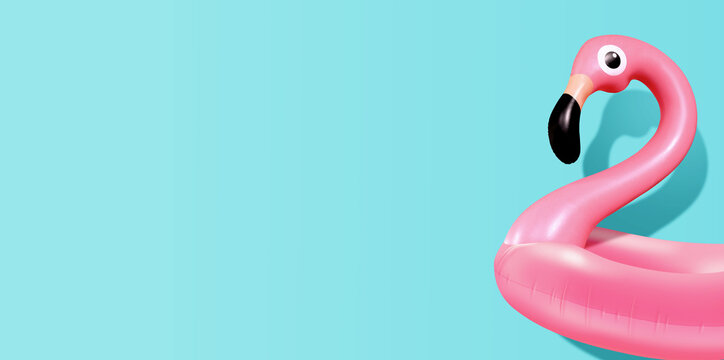 Trendy Summer composition made of pink flamingo inflatable on bright light blue background.Minimal summer concept.Creative art,Contemporary style.Banner background with writing space and copy space.