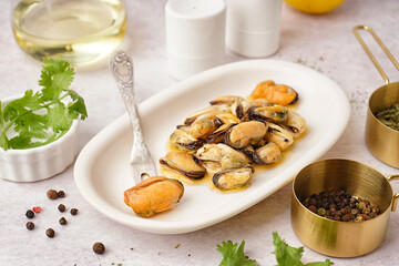 Plate with pickled mussels on white background