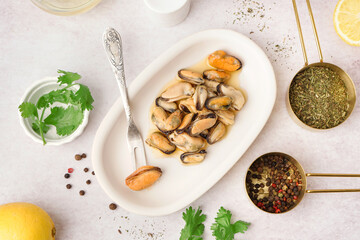 Plate with pickled mussels on white background