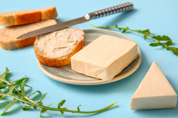 Plate and sandwich with processed cheese on blue background