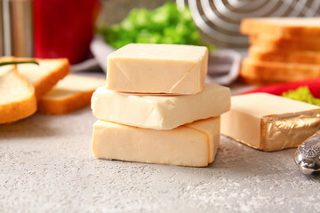 Processed cheese and bread on grunge background