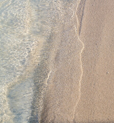 Ocean Waves on Tan Sand in Hawaii.