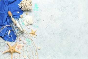 Bottle with letter, sea shells, starfishes and net on grunge background